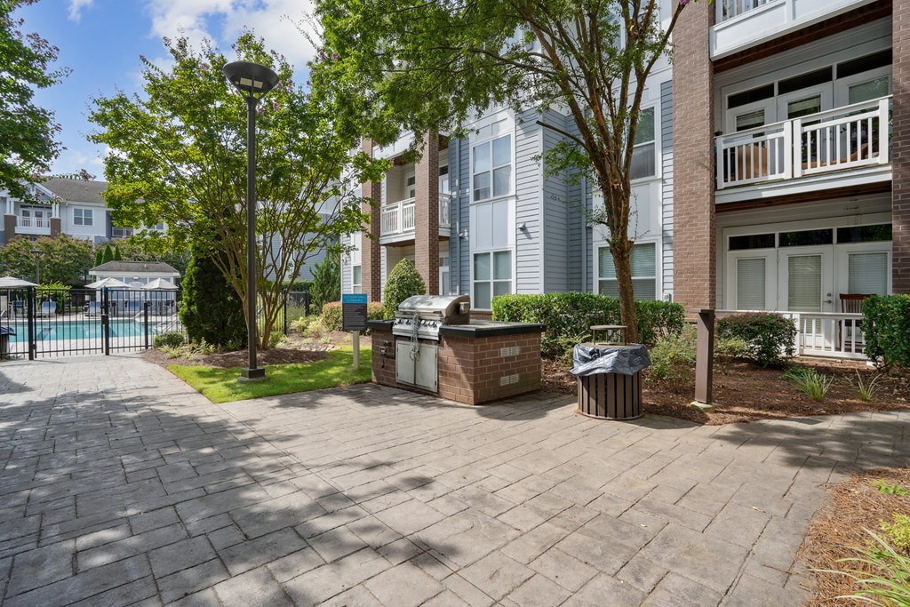 A sunny day at a residential area with apartment buildings and a pool.