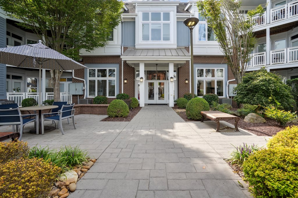 A patio area with a table and chairs outside a building.