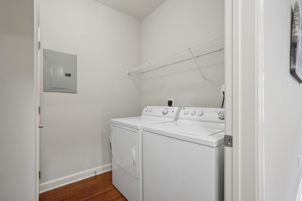 A white oven and microwave in a small kitchen.