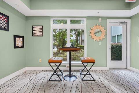 A dining room with a table and two chairs.