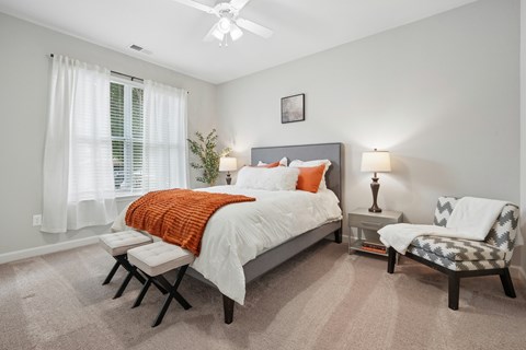 bedroom with a bed, chair, and a ceiling fan.
