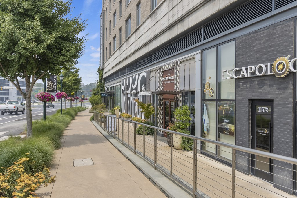 a sidewalk in front of a building with a sign on it