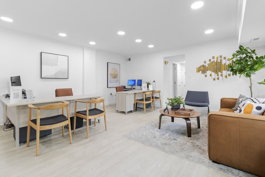 a common room with a desk and chairs and a couch