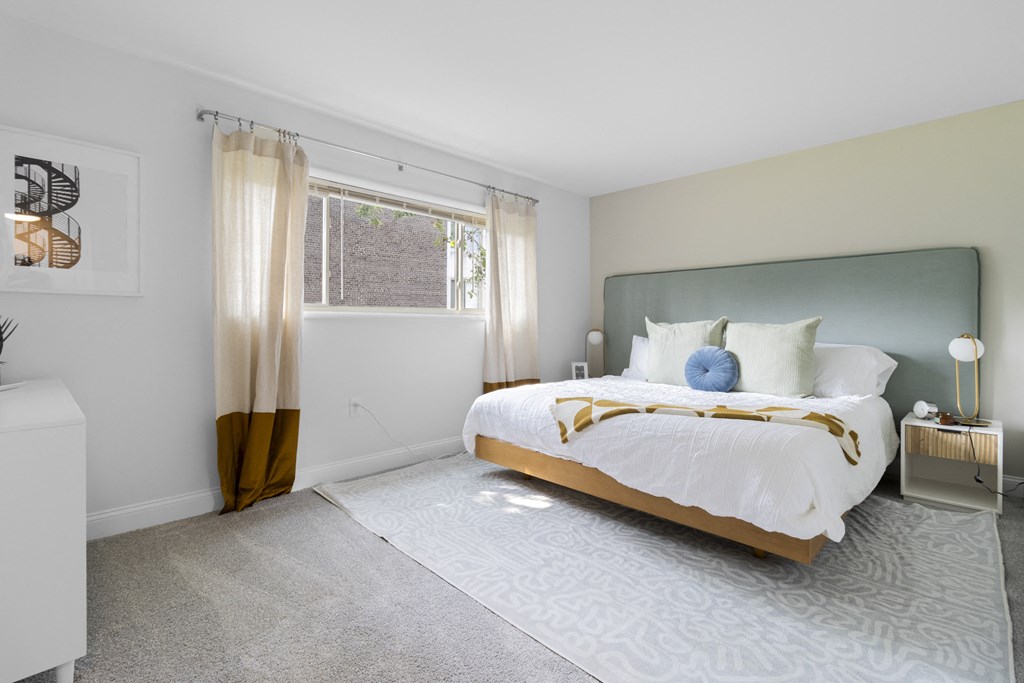 a bedroom with a bed and a window