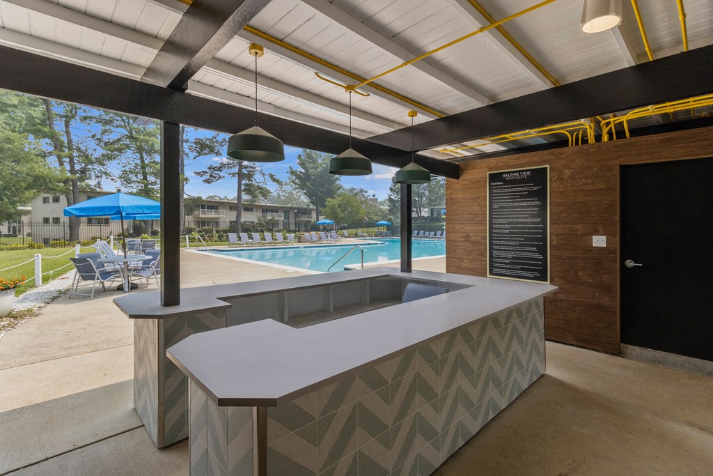 a poolside bar in the clubhouse of a resort with a swimming pool