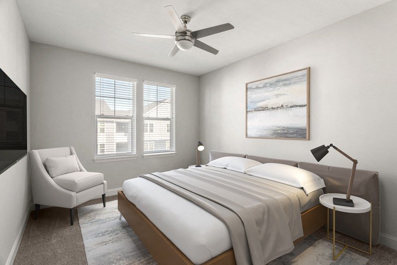 a bedroom with a bed and a ceiling fan