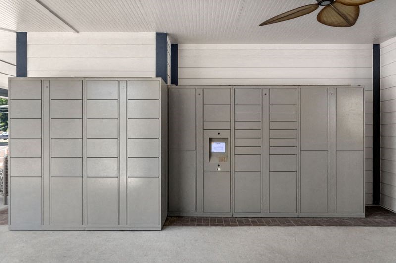 a room with a ceiling fan and several closets