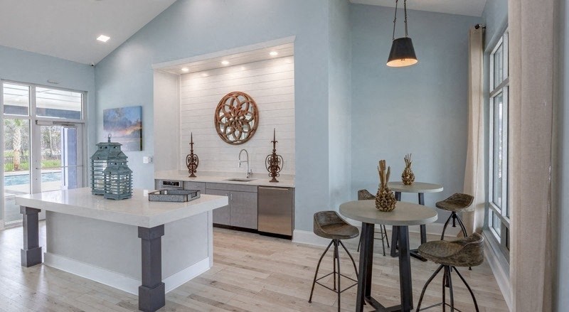 a kitchen and dining area with a table and stools