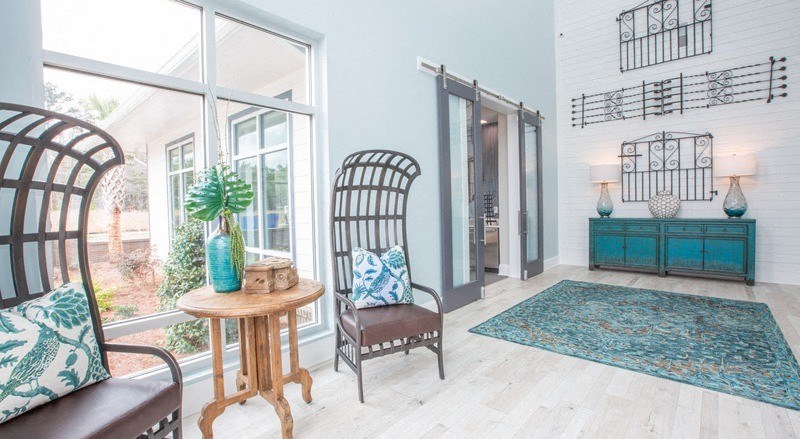 a living room with two chairs and a door to a porch