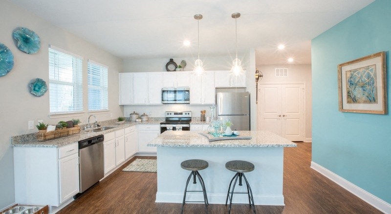 a kitchen with an island with two stools