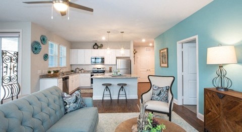 a living room and kitchen with a couch and a table