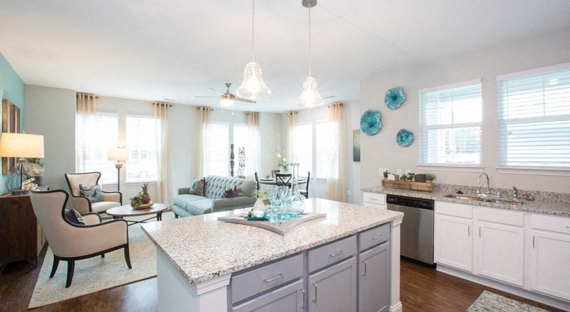 a kitchen and living room with a counter top