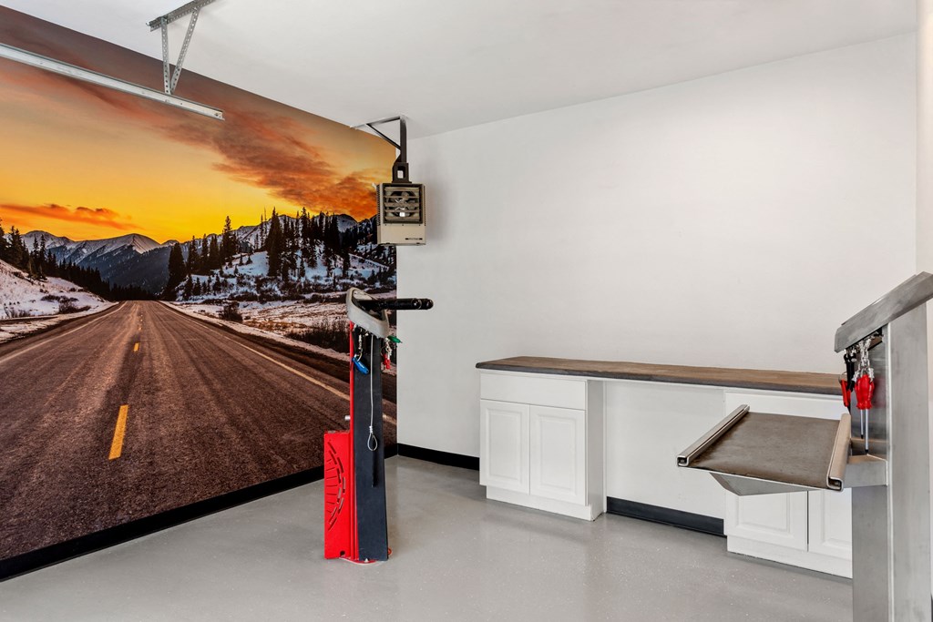 the kitchen has a counter and a wall mural of a road on the wall