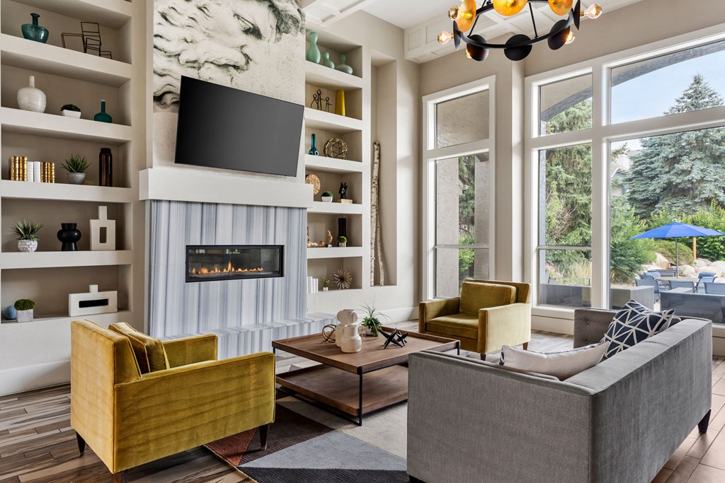 a living room with a fireplace and a large window