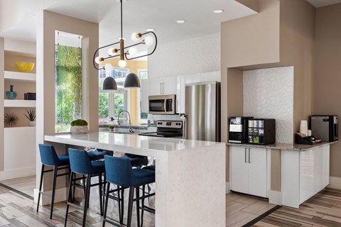 a kitchen with an island and blue bar stools