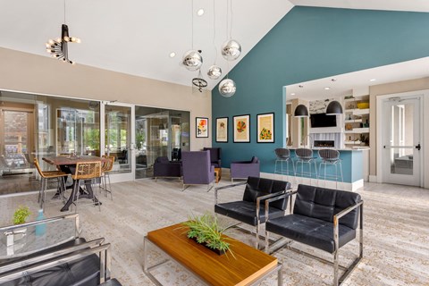 a living room with blue walls and a table and chairs