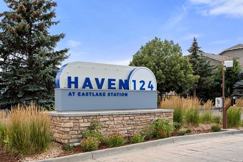 a sign for haveen 144 at eastgate station in front of trees