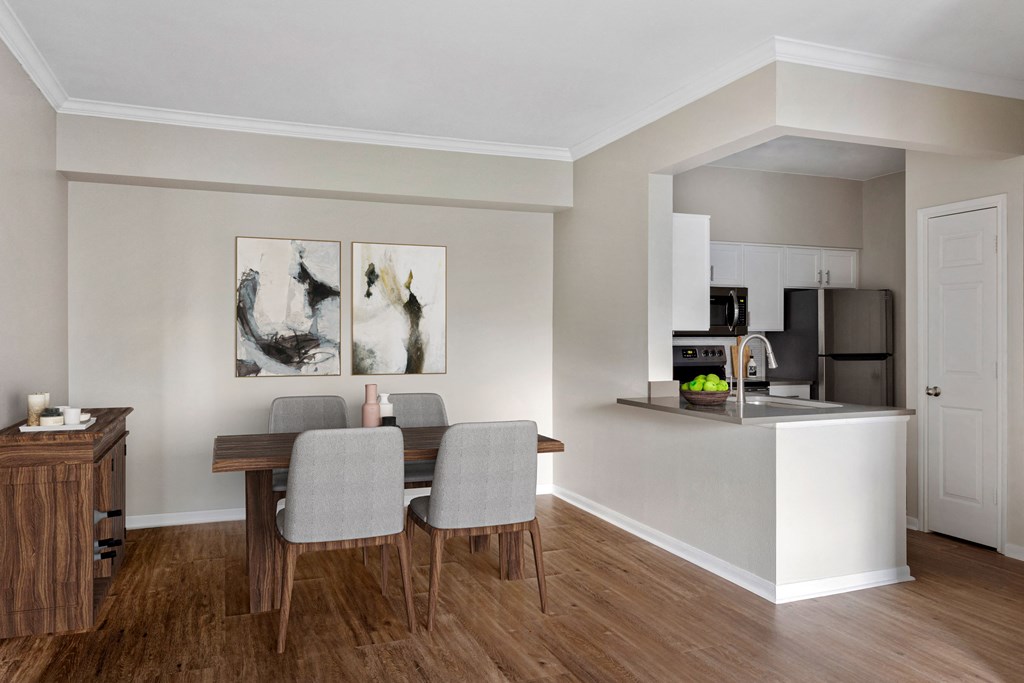 a dining room and kitchen with a table and chairs