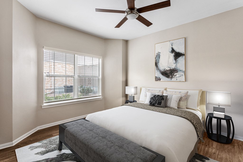 a bedroom with a bed and a ceiling fan