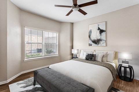 a bedroom with a bed and a ceiling fan