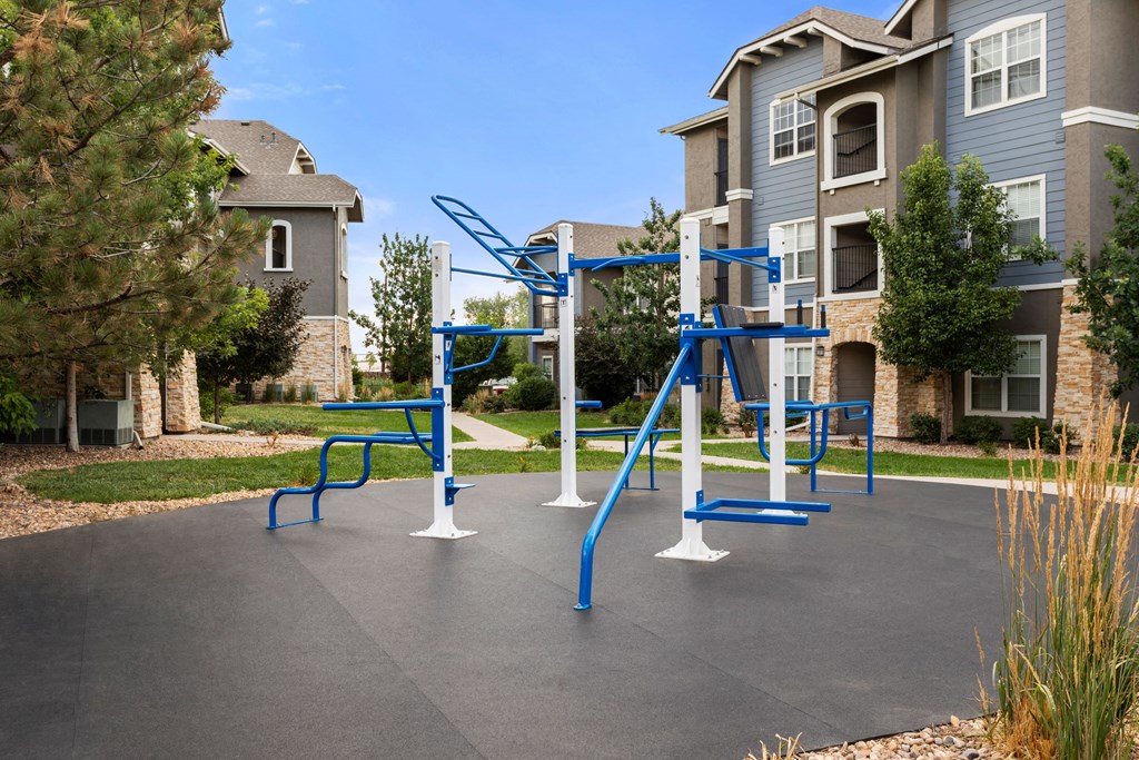 an outdoor playground in front of an apartment building