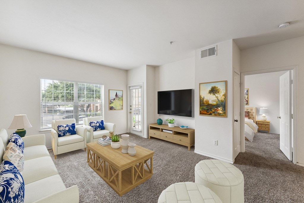 a living room with white furniture and a large window