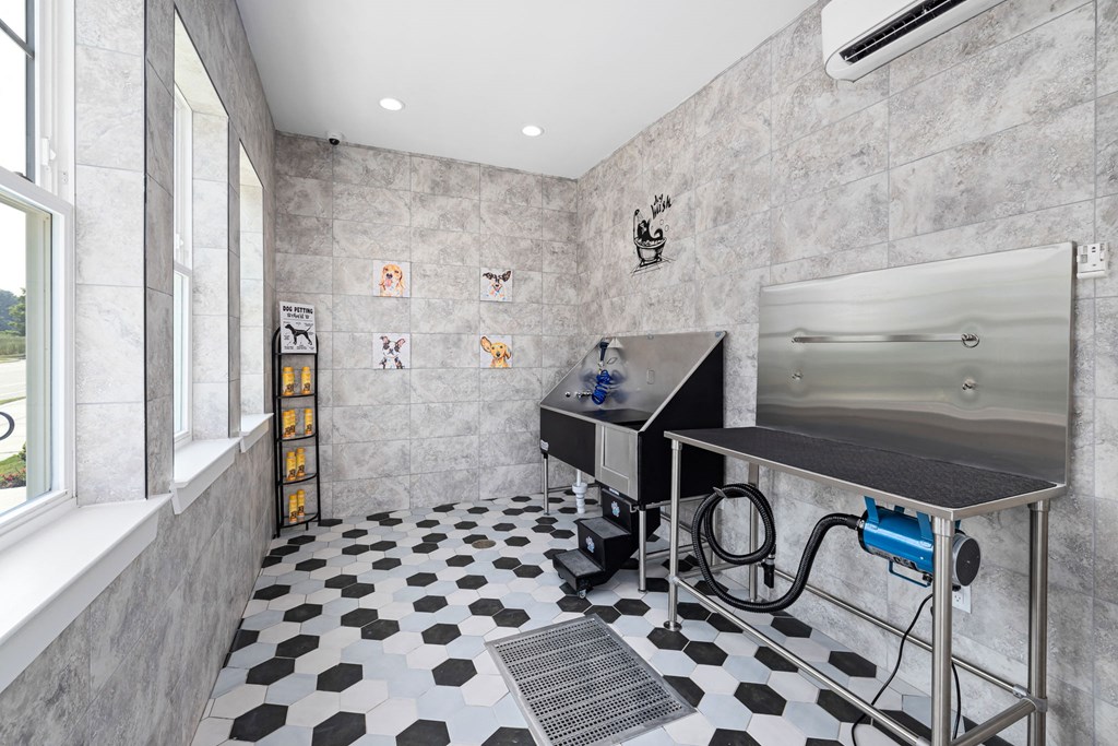 a home gym with a black and white tiled floor and gray walls