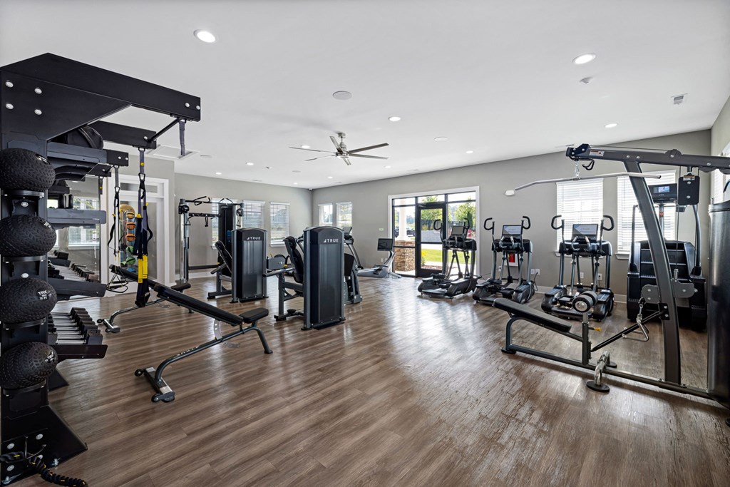 a gym with cardio machines and weights