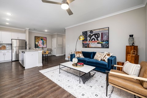 A living room with a blue couch and a coffee table.