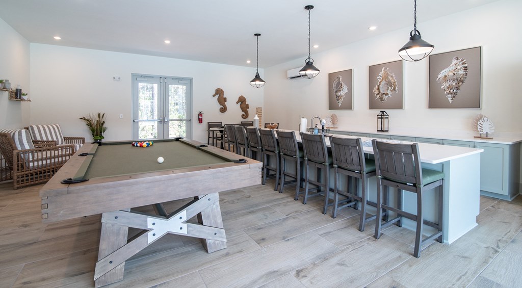 a game room with a pool table and a bar