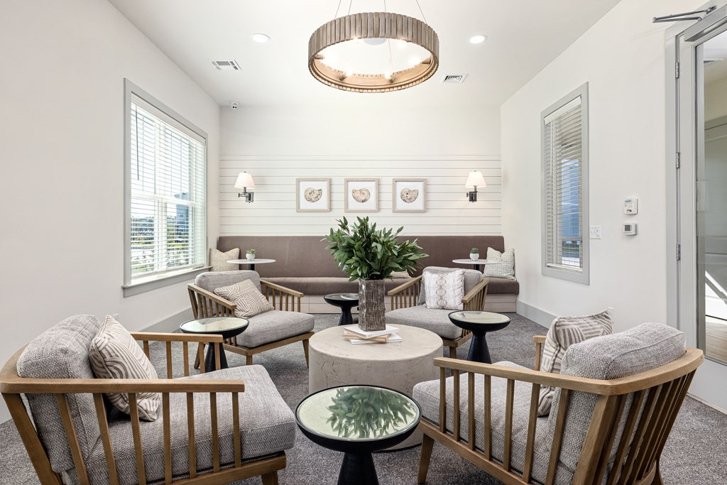 a living room filled with furniture and a chandelier