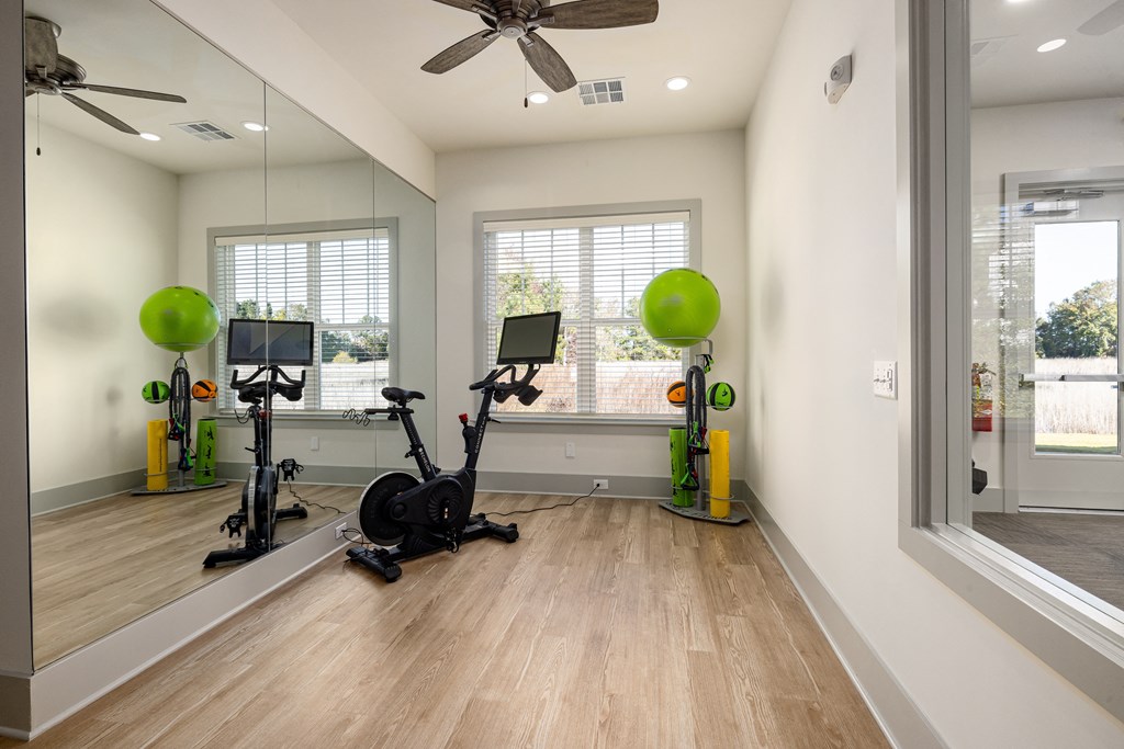 a home gym with exercise equipment and a window