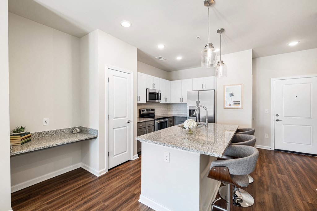 a kitchen with an island and a bar with stools