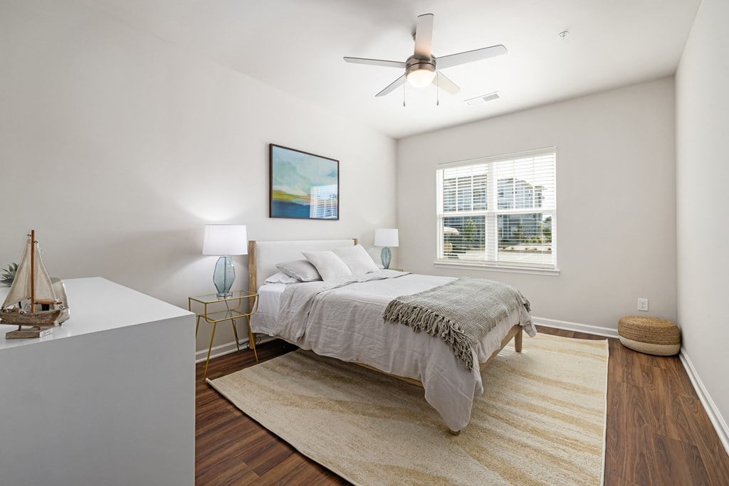 a bedroom with a bed and a ceiling fan