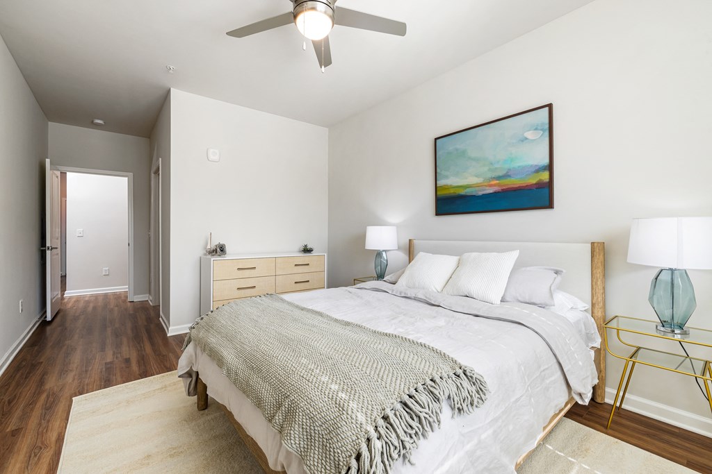 a bedroom with a large bed and a ceiling fan