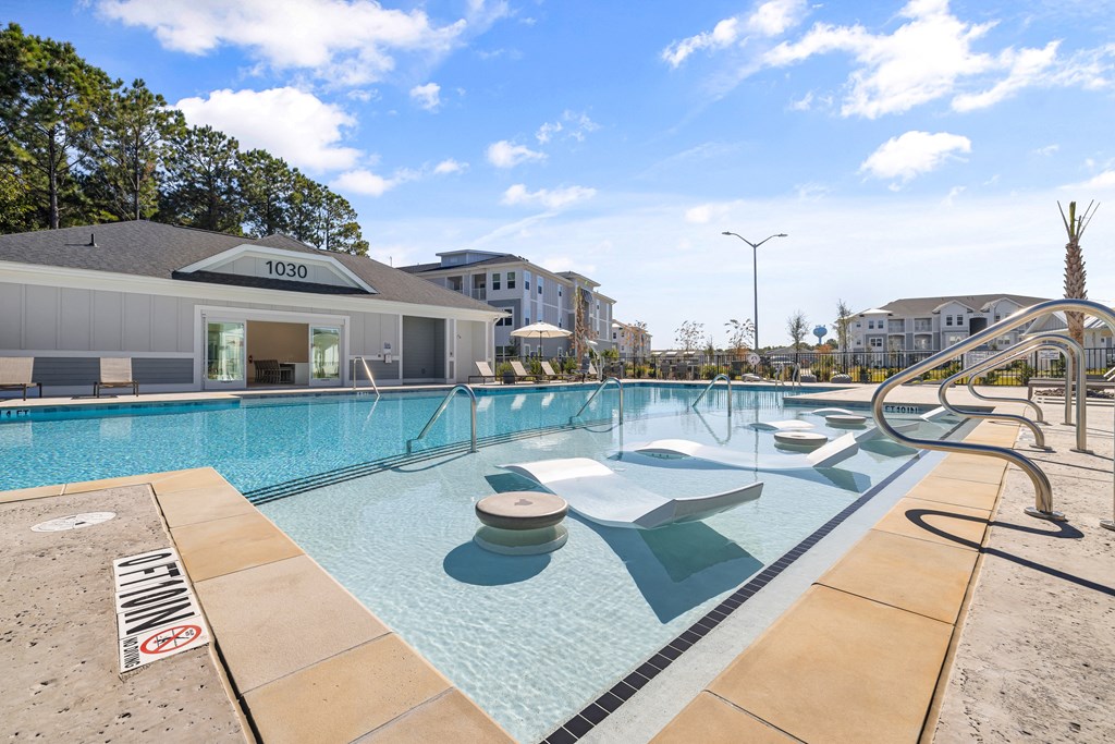 the preserve at ballantyne commons resort style pool with lounge chairs and water feature