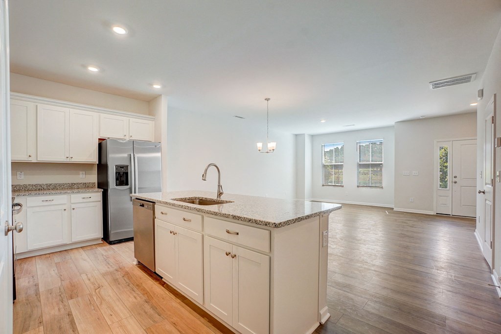 a large kitchen with white cabinets and a counter top