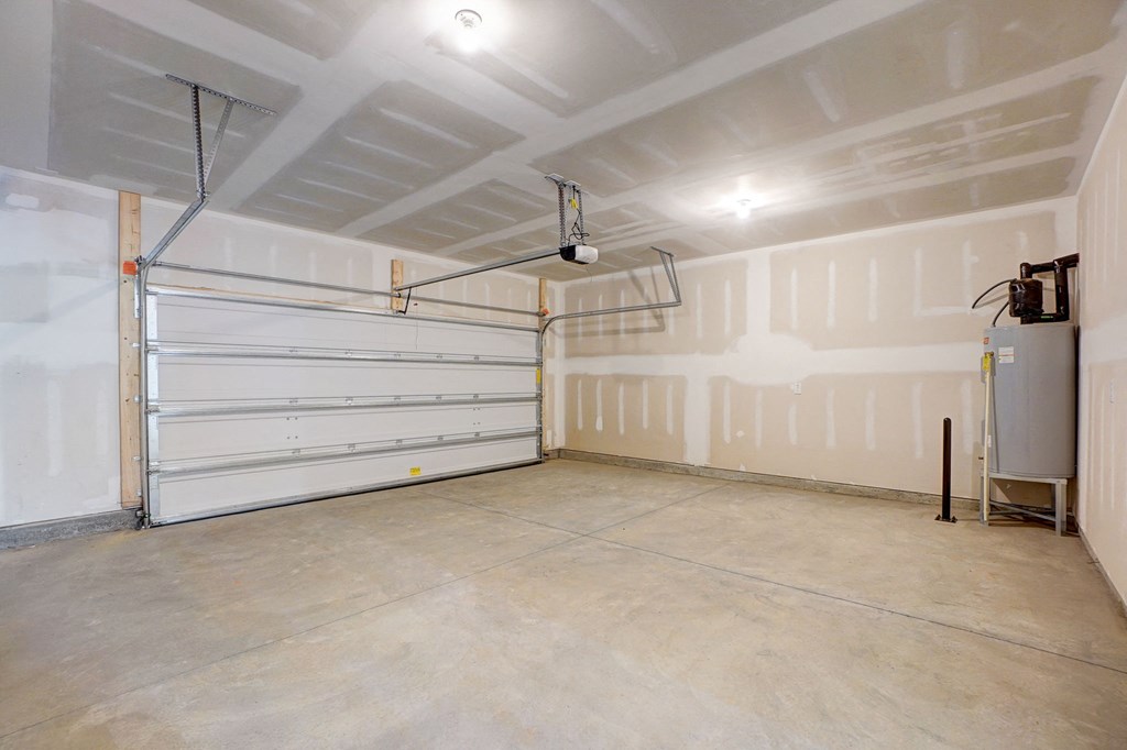 the inside of a garage with a white garage door