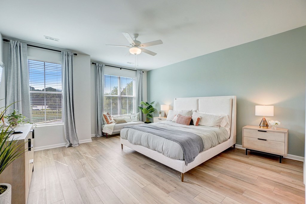 a bedroom with a bed and a ceiling fan