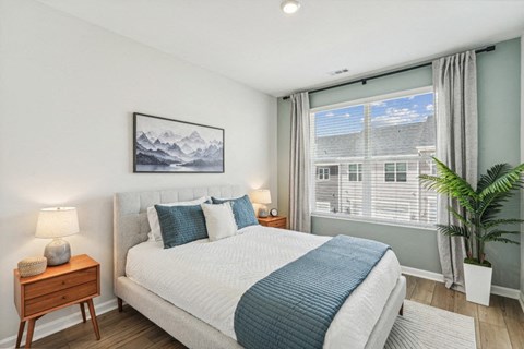 a bedroom with a bed and a large window