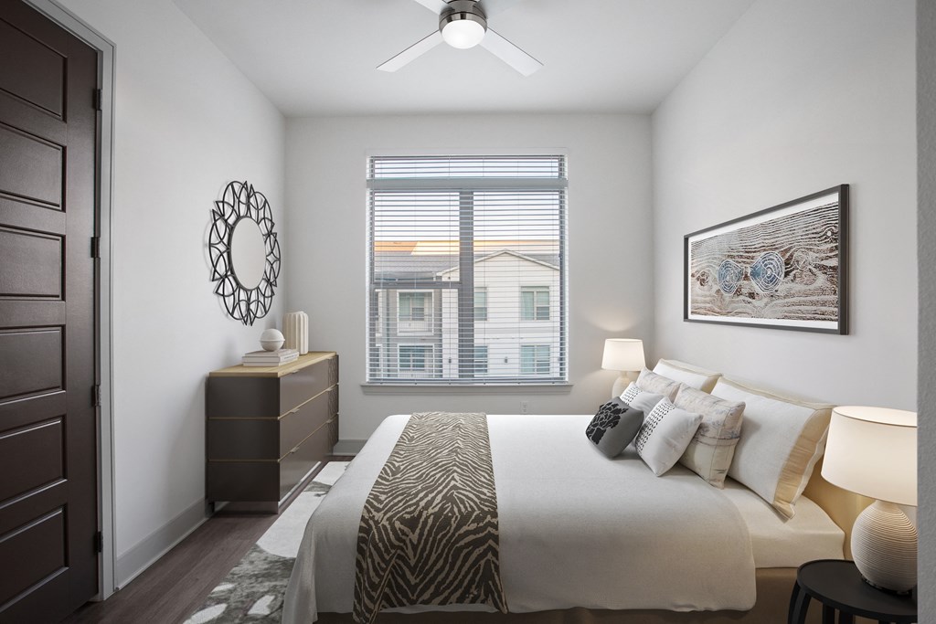 a bedroom with a large bed and a window