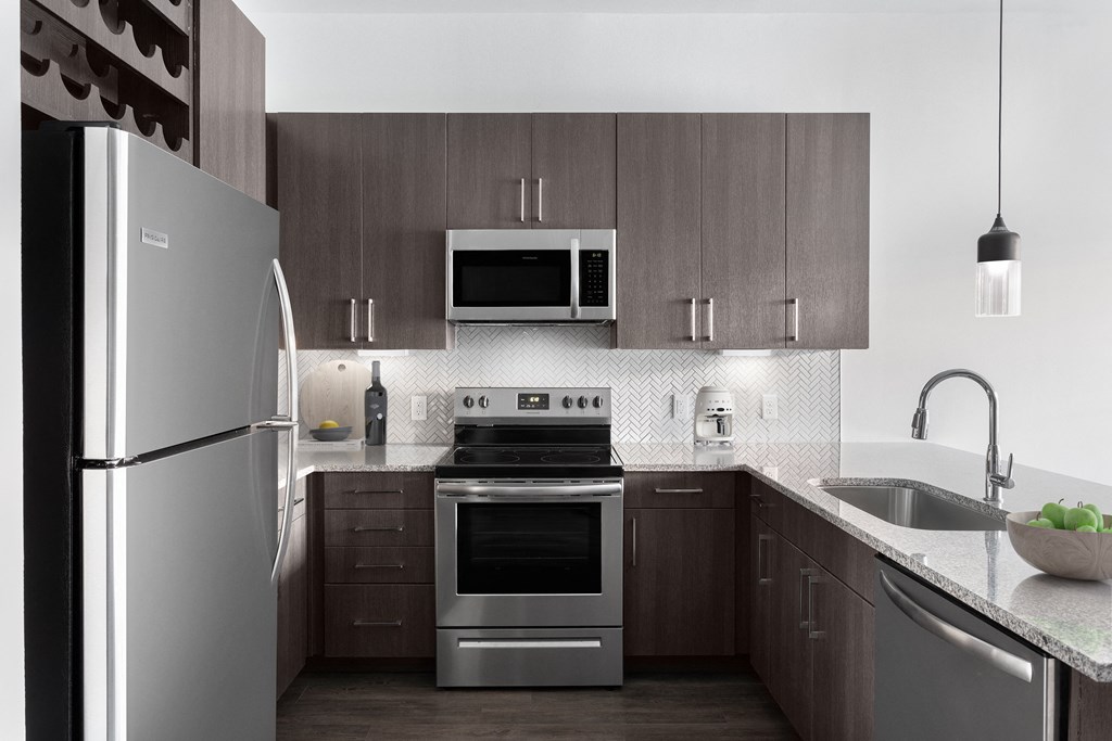 a kitchen with stainless steel appliances and wooden cabinets