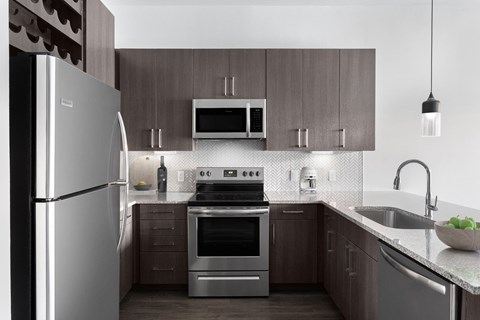 a kitchen with stainless steel appliances and wooden cabinets