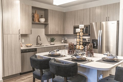 a kitchen and dining room with a table and chairs