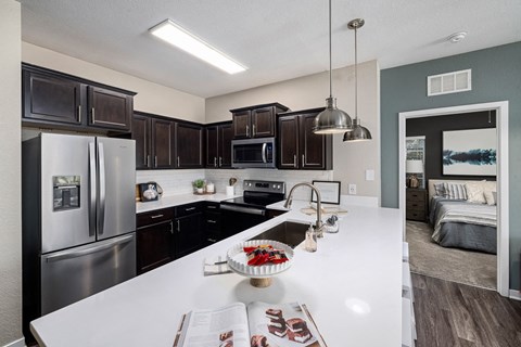 a kitchen with stainless steel appliances and a white counter top