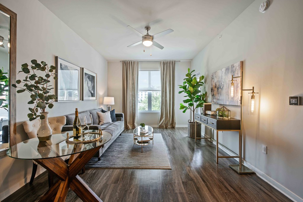 A modern living room with a glass table and a glass coffee table.