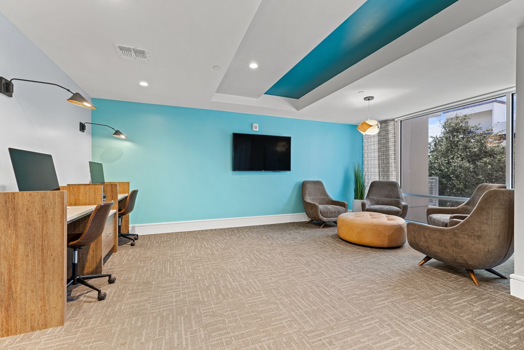 A room with a blue wall and a television mounted on it.