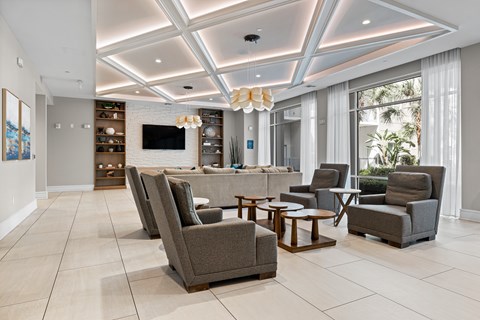 A living room with a grey sofa and a white coffee table.