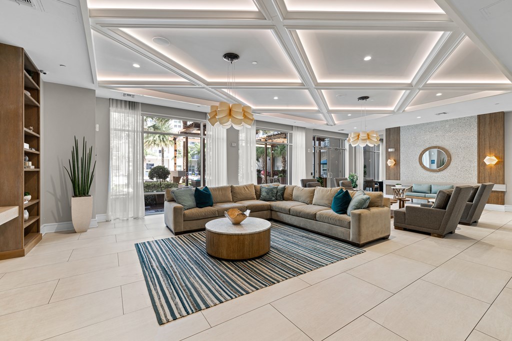 A spacious living room with a large sectional sofa, a coffee table, and a rug.