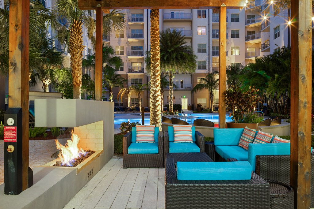 A patio with a fireplace and couches.